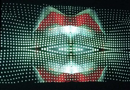 Computer generated illustration made up of illuminated, coloured dots, making an image of a persons lips, mouth and teeth.