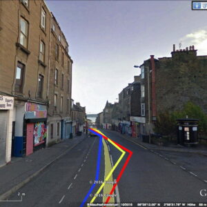 A view of a street with red,yellow and blue lines superimposed on the road.