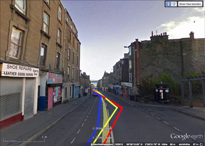 A view of a street with red,yellow and blue lines superimposed on the road.
