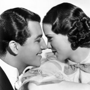 Black and white photo of two 1930's style movie stars gazing into each others eyes.