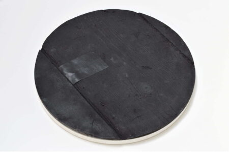 A black wooden disc on a white background.