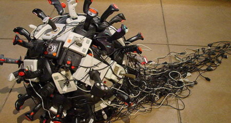 A collection of computer joysticks arranged into a ball.