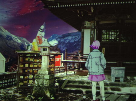 A photographic image of a Japanese temple. Superimposed over the top of this image is an animated character looking at the temple. The character is wearing a blue denim jacket and a pink skirt and pink hair.