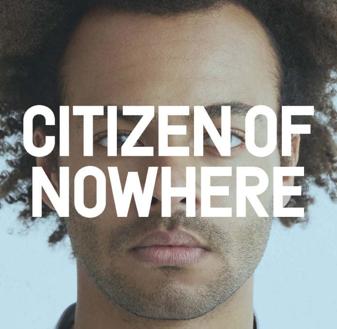 A person looking head on with the words Citizen of Nowhere written in large white writing.