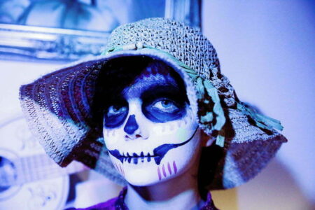 Child dressed up in Day of the Dead style make up.