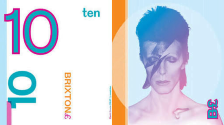 A Brixton Ten Pound Note. One side of the note has the number 10 coloured teal with pink outline on a white background. The other side of the note has an image of David Bowie in his Ziggy Stardust phase.