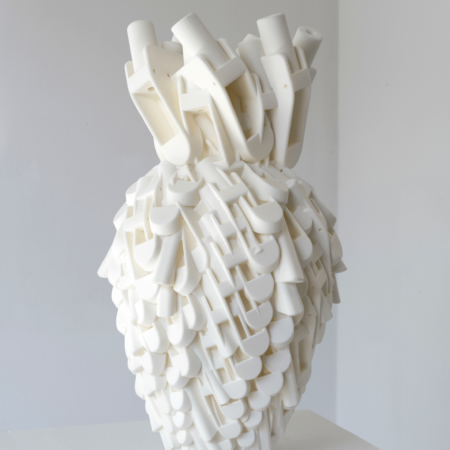 A white vase. The body of the vase is made up of musical notes. The neck of the vase is made up of whistles.