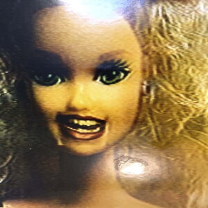 A Barbie doll that looks like she is laughing.