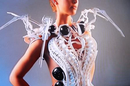 A person wearing a dress that looks like a spiders skeleton.
