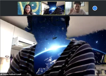 Screen grab of zoom call, experimenting with virtual backgrounds.