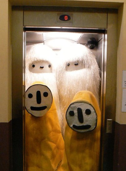 Aki costumes and pictoplasma costumes in a lift with the door open. 