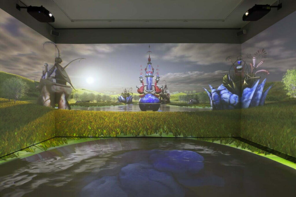 Large room with digital illustrations of a fantasy type landscape projected on the walls